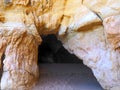 View of a cave through a opening in a Algarve cave in Portimao Portugal at praia da rocha Royalty Free Stock Photo