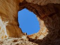 View of the sky through a opening in a Algarve cave in Portimao Portugal Royalty Free Stock Photo