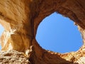 View of the sky through a opening in a Algarve cave in Portimao Portugal Royalty Free Stock Photo