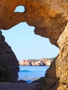 View of the sea through a opening in a Algarve cave in Portimao Portugal at praia da rocha Royalty Free Stock Photo