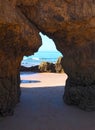 View of the sea through a opening in a Algarve cave in Portimao Portugal at praia da rocha Royalty Free Stock Photo