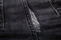 Hole on dark denim jeans. Royalty Free Stock Photo