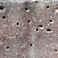 Hole in the destruction concrete wall, bullet hole, abstract background free space for design after war