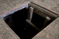 Hole in floor of old house leading to cellar