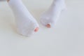 Hole in gray sock shows big female toe. Royalty Free Stock Photo