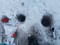 Hole in the ice, a short pole for ice fishing Royalty Free Stock Photo