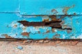 A hole in metal sheet iron blue. Royalty Free Stock Photo