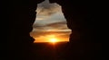 A hole in a mud wall overlooking the sunset Royalty Free Stock Photo