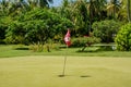 Hole number 3 with red flag at the mini golf field Royalty Free Stock Photo