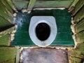 Hole of the old dirty country toilet, rural toilet inside, top view