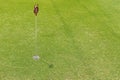 Hole at putting cup hold showing number one pin at outdoor practice putting green Royalty Free Stock Photo