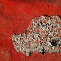 Hole in red concrete wall