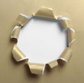 Hole ripped in gold paper