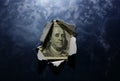 Hole ripped in textured metallic background  with hundred dollar bill Royalty Free Stock Photo