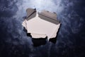Hole ripped in textured metallic background surface with white copy space center Royalty Free Stock Photo