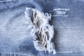 Hole and thread denim blue jeans, ripped torn jeans texture. Royalty Free Stock Photo