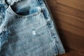 Hole and Threads on Denim Jeans. Ripped Destroyed Torn Blue jeans background. Royalty Free Stock Photo