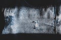 Hole and Threads on Denim Jeans. Ripped Destroyed Torn Blue jeans background. Royalty Free Stock Photo