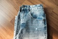 Hole and Threads on Denim Jeans. Ripped Destroyed Torn Blue jeans background. Royalty Free Stock Photo