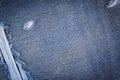 Hole and Threads on Denim Jeans.  Jeans torn denim texture. Royalty Free Stock Photo