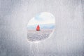 A hole in a wall with sailing boat on the calm sea. Concept restricted area, freedom. Copy space