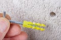 Hole in the wall, screw and dowel for fixing in concrete. Wall mounting methods Royalty Free Stock Photo