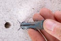 Hole in the wall, screw and dowel for fixing in concrete. Wall mounting methods Royalty Free Stock Photo