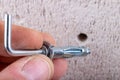 Hole in the wall, screw and dowel for fixing in concrete. Wall mounting methods Royalty Free Stock Photo