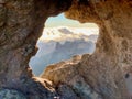 Hole window mountain view on a rock