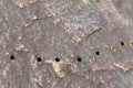 Holes drilled in a granite rock face, dynamite of drainage, creative copy space