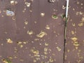 Holes on the gate from the explosion of the projectile. A trace on the fence from bullets and shrapnel. Traces of war on a metal