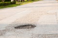 Holes on the road. dangerous pothole in the asphalt highway.Outdoor Royalty Free Stock Photo