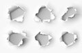 Holes torn in paper on white Royalty Free Stock Photo