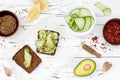 Holewheat toast with avocado guacamole and cucumber slices. Breakfast with spicy avocado sandwiches on whole grain bread. Royalty Free Stock Photo