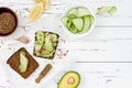 Holewheat toast with avocado guacamole and cucumber slices. Breakfast with spicy avocado sandwiches on whole grain bread. Royalty Free Stock Photo