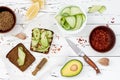 Holewheat toast with avocado guacamole and cucumber slices. Breakfast with spicy avocado sandwiches on whole grain bread. Royalty Free Stock Photo