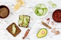 Holewheat toast with avocado guacamole and cucumber slices. Breakfast with spicy avocado sandwiches on whole grain bread. Royalty Free Stock Photo