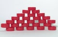 Holey wall pattern of red ribbed plastic bottle caps, relying on