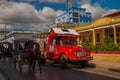 Holguin, Cuba: An old retro red truck serves as a taxi in the city.