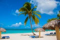 Holguin, Cuba, Playa Esmeralda. Beautiful Caribbean sea turquoise blue color and palm trees on the beach. Sun loungers and umbrell Royalty Free Stock Photo