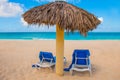 Holguin, Cuba, Playa Esmeralda. Umbrella and two sun loungers are on the sand. Tropical and Paradise beach on the Caribbean sea. Royalty Free Stock Photo