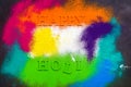 Holi background with colored powder. Holi festival, traditional Indian holiday. Happy holi lettering