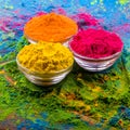 Holi color powder. Organic Gulal colours in bowl for Holi festival, Hindu tradition festive. Bright vibrant pigment closeup