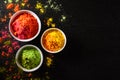 Holi festival celebration. Traditional Indian Holi colours powder decoration with paints. Top view of Organic Gulal colors in Royalty Free Stock Photo