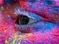 Holi Festival color on face eye closeup