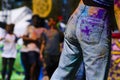 Holi festival in St. Kilda, Australia: girl with dirty jeans