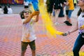 Holi festival. Young cheerful people under explosion of colored powder at Holi colors party. Royalty Free Stock Photo