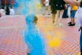 Holi festival. Young cheerful people under explosion of colored powder at Holi colors party. Royalty Free Stock Photo