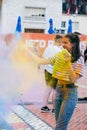 Holi festival. Young cheerful people under explosion of colored powder at Holi colors party. Royalty Free Stock Photo