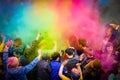 Holi Indian holiday. Young people in the crowd throw colored powders up and have fun. Close up